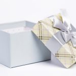 Closeup picture of a beautiful open present package over a white background